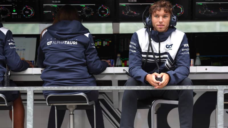 Pierre Gasly sits on the AlphaTauri F1 pitwall