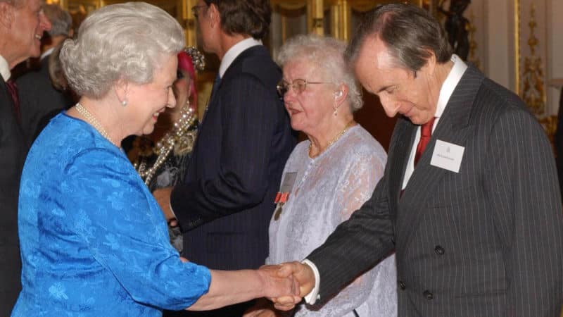 Sir Jackie Stewart shakes hands with the Queen in 2003