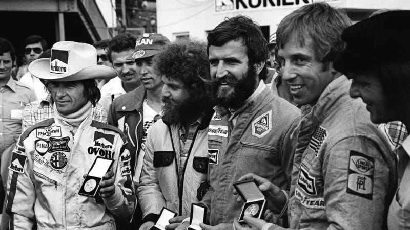 Merzario, left, receives a medal along with a representative of Guy Edwards, Harald Ertl and Brett Lunger for saving Niki Lauda’s life