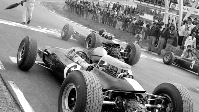 Flamboyant Watkins Glen starter Tex Hopkins prepares to send the field away ahead of the 1965 United States GP