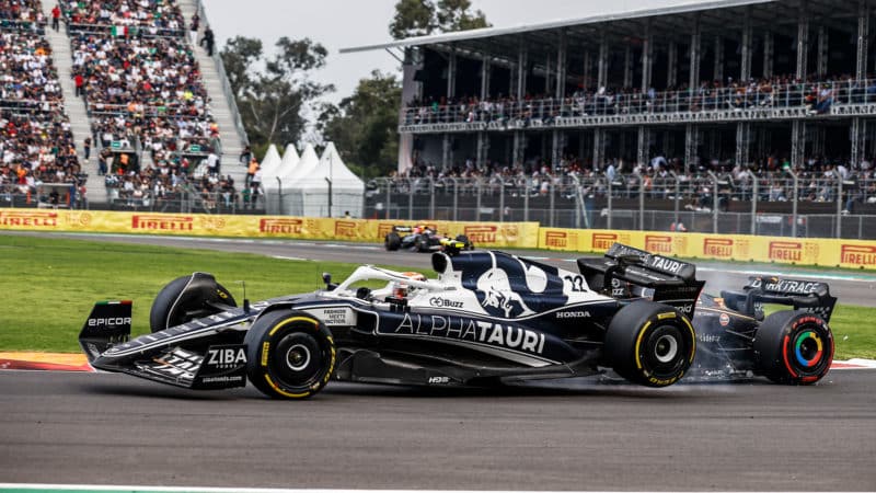 AlphaTauri of Yuki Tsunoda is tilted as he hits Daniel Ricciardo in the 2022 Mexican Grand Prix