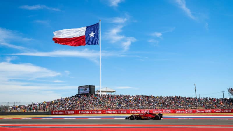 Carlos Sainz drives past COTA crowd and Texas flag at 2022 US GP qualifying