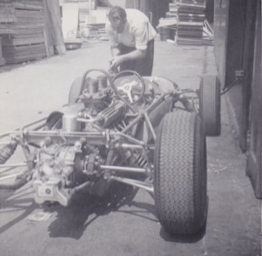 Denny Hulme washing single seater car in 1964