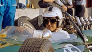 Denny Hulme wearing sunglasses in Brabham cockpit at Monza in 1966