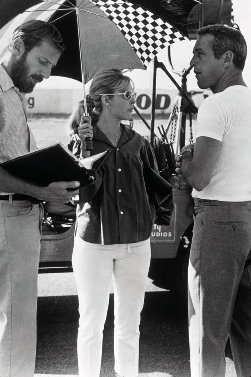 Newman with Goldstone and Woodward on set. His part in the film allowed Newman to indulge in the lifestyle of racing. It would be a catalyst to him launching his own driving career later in his life, culminating in a podium at Le Mans