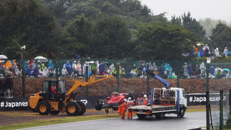 Ferrari of Carlos Sainz is recovered from the side of the track at Suzuka at the 2022 Japanese Grand Prix
