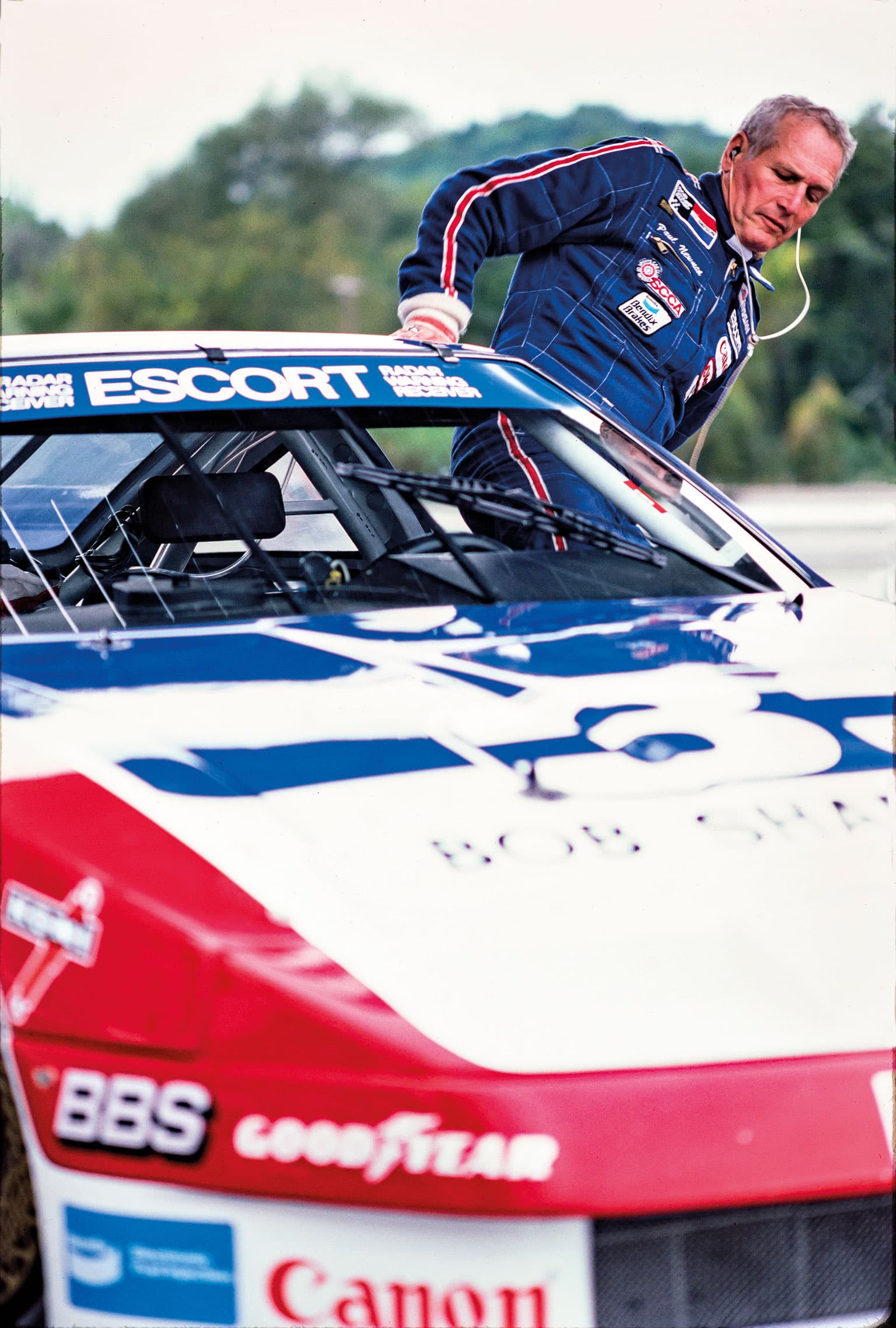 Newman climbs into one of his race cars