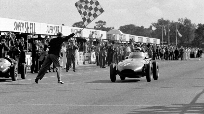 Stirling Moss crosses the line to win the 1957 British Grand Prix