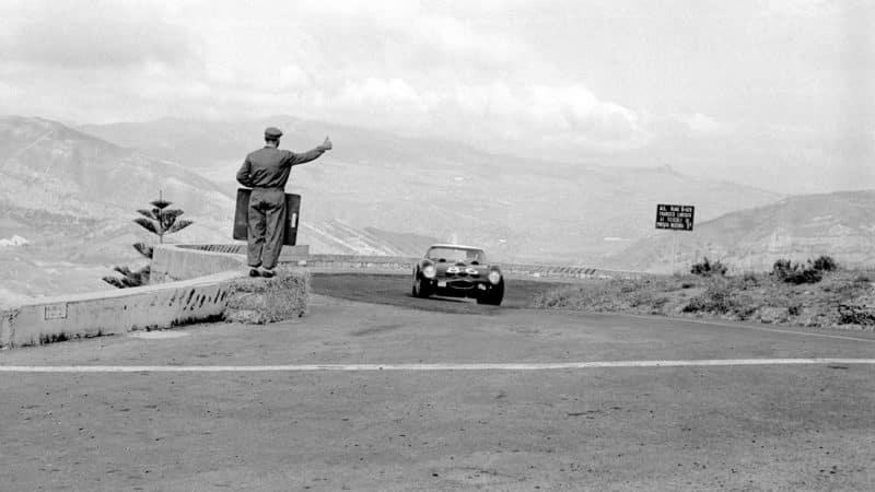 An engineer gives the thumbs up to a speeding GTO during the 1952 Targa Florio