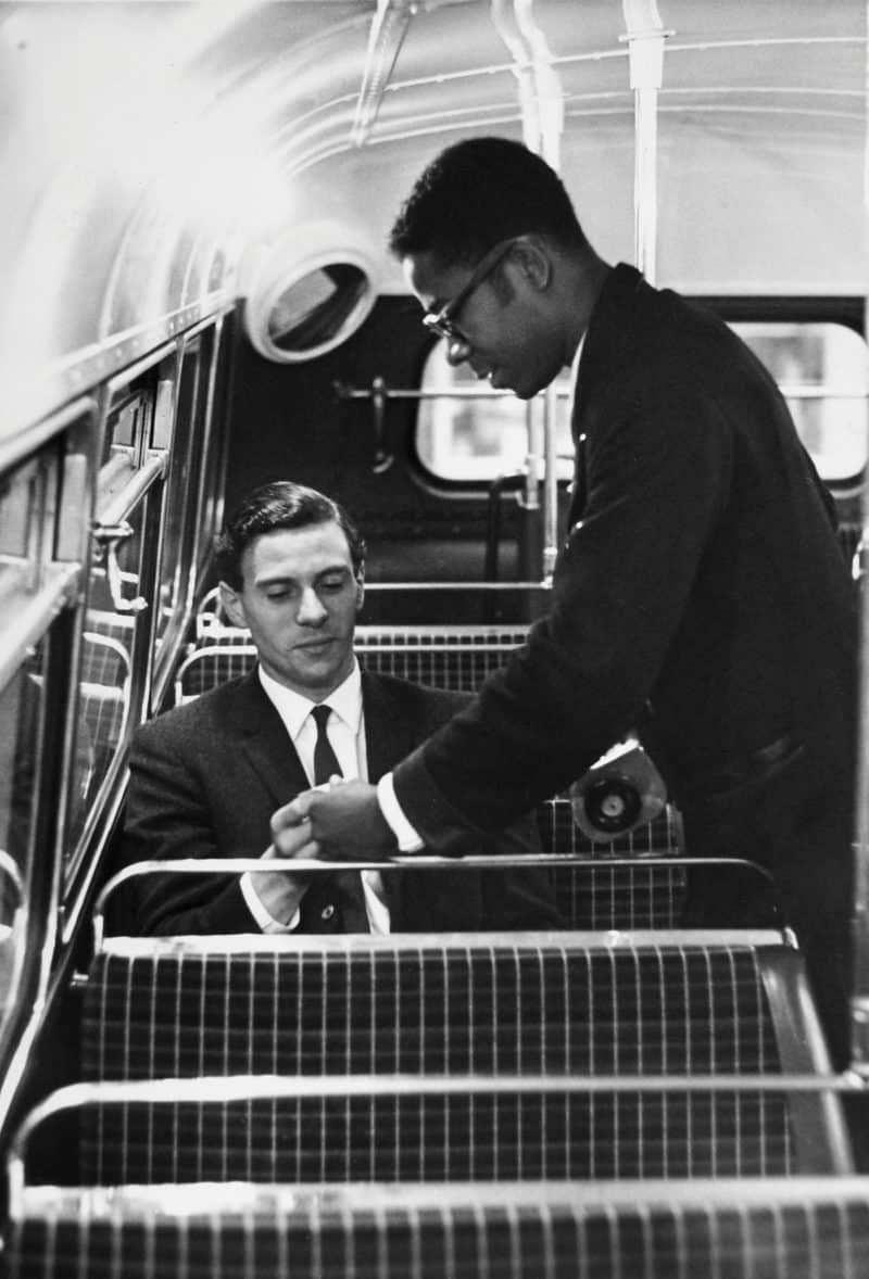 Jim Clark has his ticket checked by a conductor while travelling on a London bus.