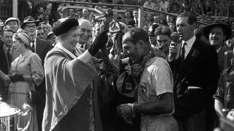 Moss being awarded the British Grand Prix spoils in 1957