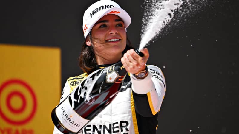 Jamie Chadwick sprays champagne on the W Series podium at Barcelona