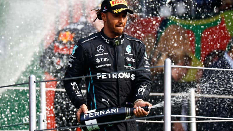 Lewis Hamilton sprays champagne on the podium after the 2022 Mexican Grand Prix