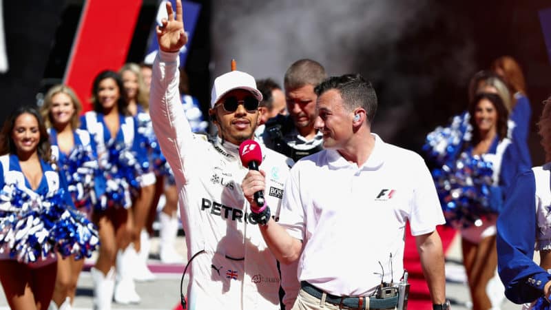 Lewis Hamilton walks to the grid past cheerleaders at the 2017 US Grand Prix