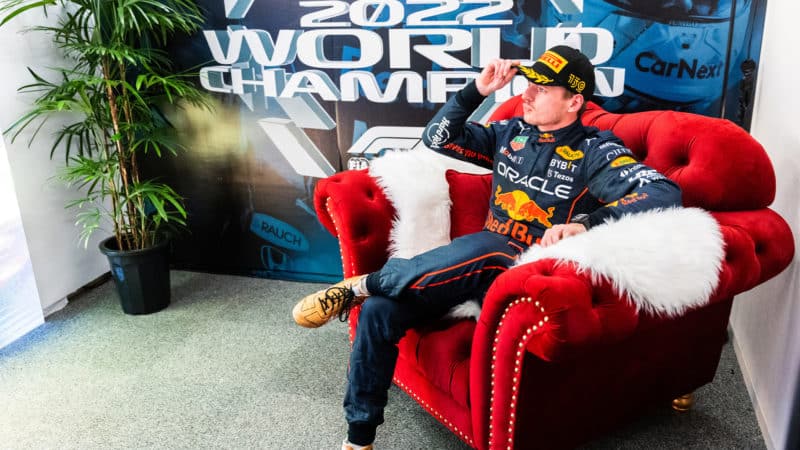 Max Verstappen sits on red armchair after winning the 2022 F1 world championship