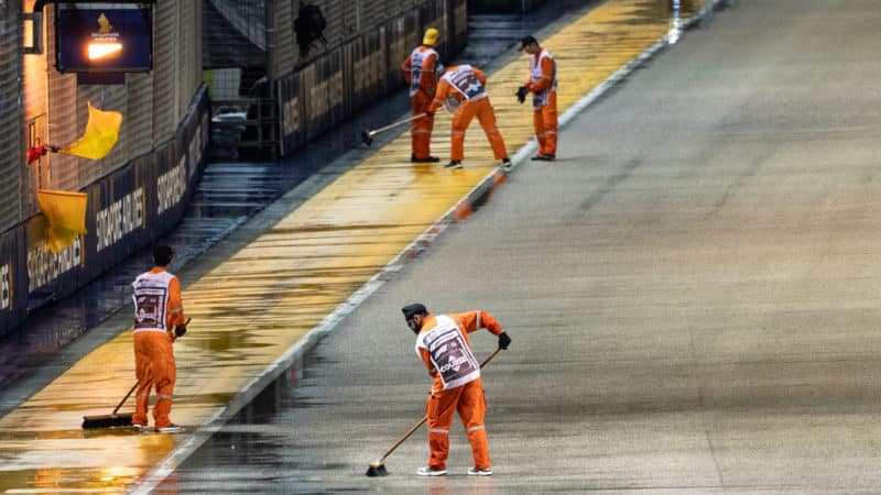 Marshalls sweep water off the circuit at the 2022 Singapore Grand Prix