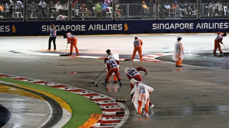 Marshals brushing race track in Singapore