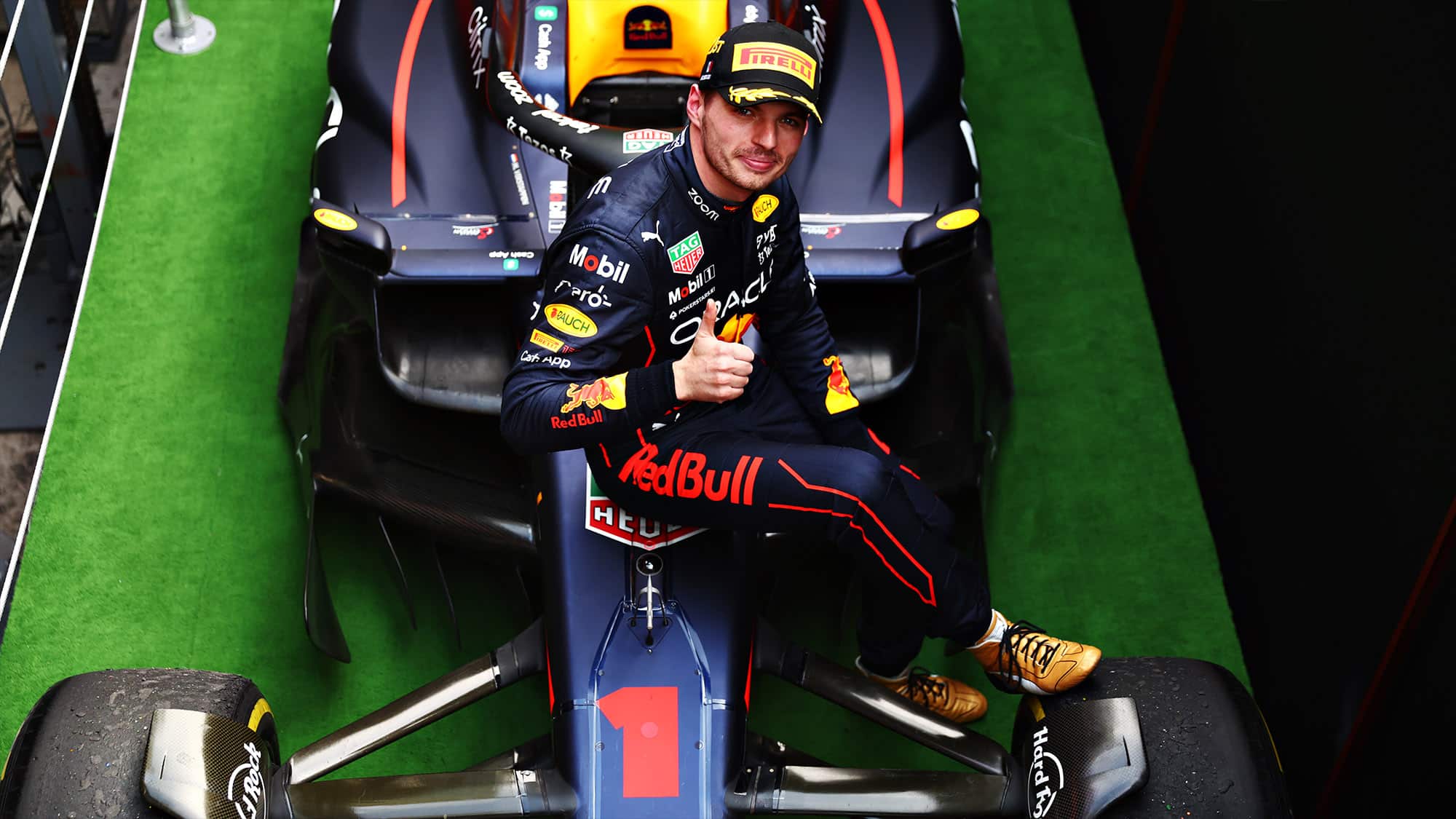 Max Verstappen gives the thumbs up as he sits on his 2022 Red Bull F1 car