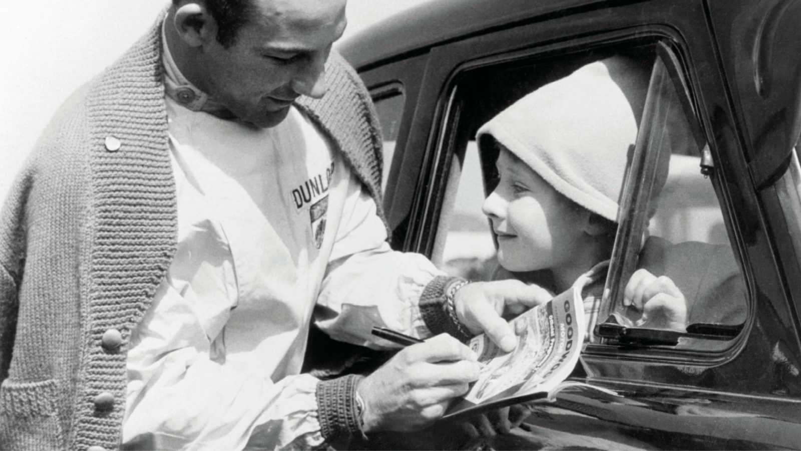 Stirling Moss signs an autograph