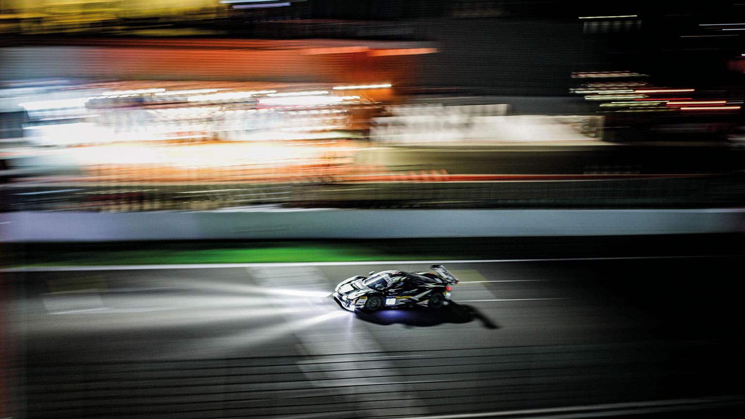 Drama under the lights at Spa as the Ferrari roars past the pits