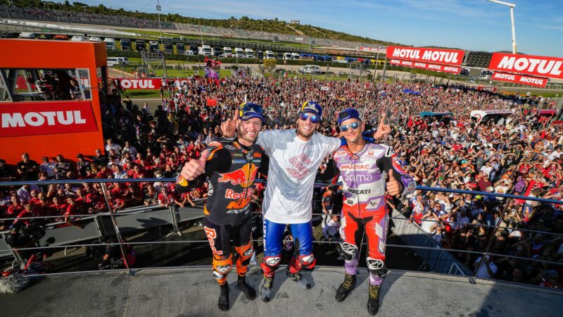 Alex Rins on the MotoGP Valencia podium with Jorge Martin and Brad Binder