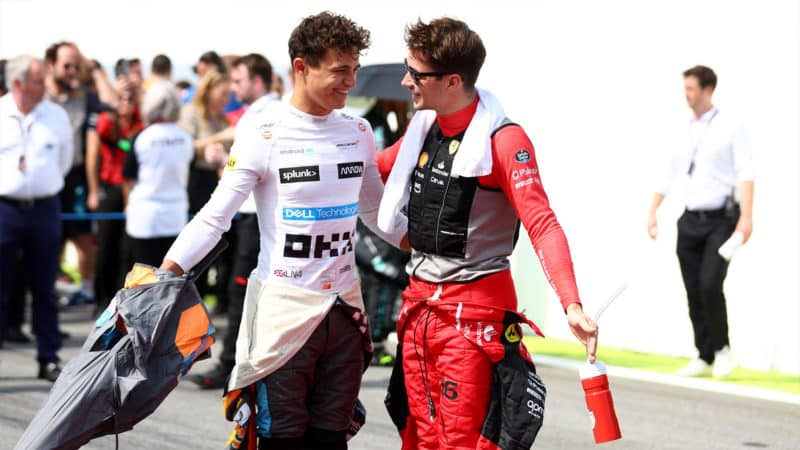 Charles Leclerc and Lando Norris smile and talk ahead of the 2022 Brazilian Grand Prix