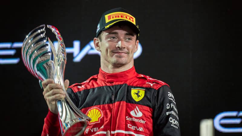 Charles Leclerc holds second place trophy on the podium after 2022 Bahrain Grand Prix