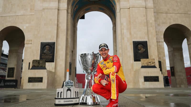 Joey Logano at LA Coliseum with NASCAR Cup Series trophy