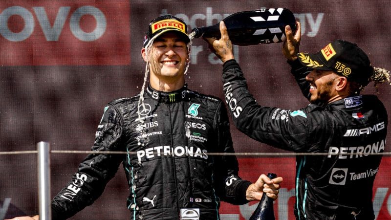 Lewis Hamilton pours champagne over George Russell on the 2022 French GP podium
