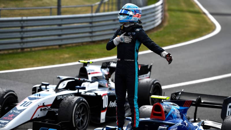 Logan Sargeant stands on his F2 car after winning the 2022 race at Silverstone