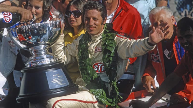 Mario Andretti with the 1971 Questor Grand Prix winners trophy