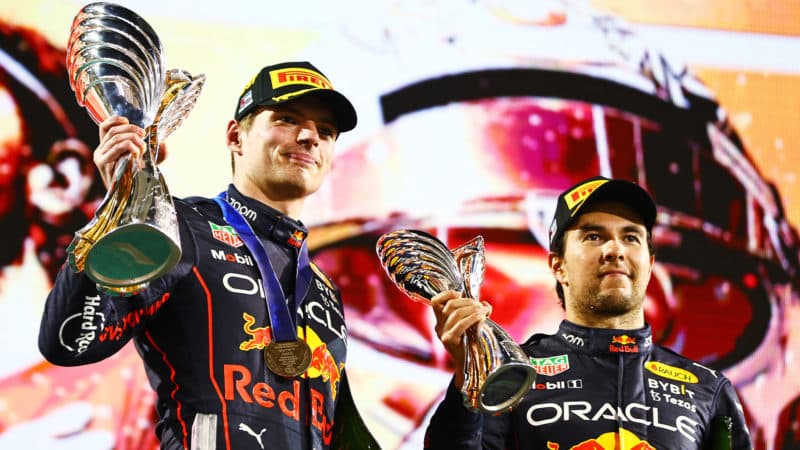 Max Verstappen and Sergio Perez hold their Abu Dhabi GP trophies
