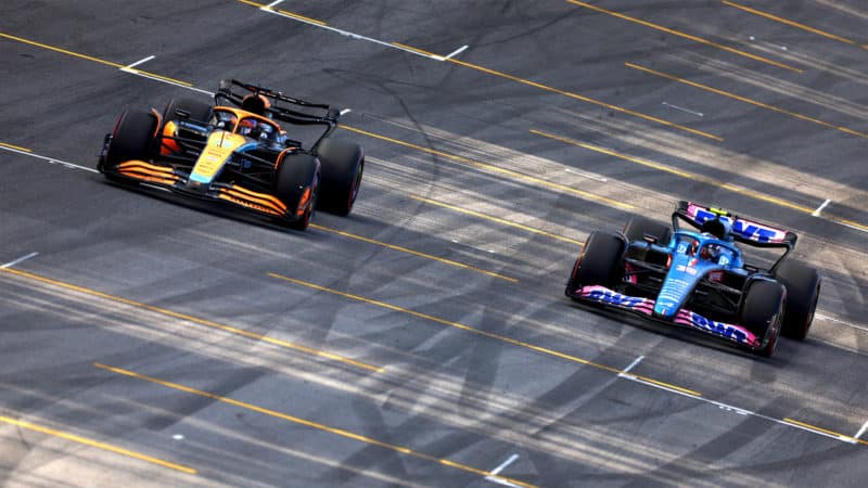 McLaren of Daniel Ricciardo alongside Alpine of Esteban Ocon in the 2022 Brazilian Grand Prix