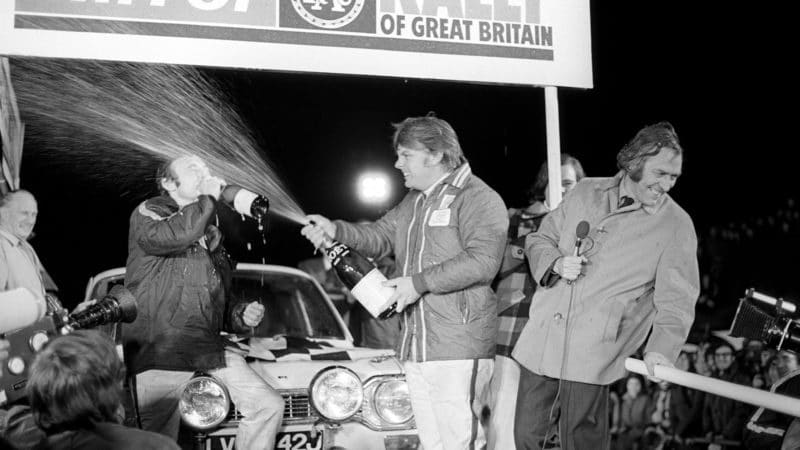 Roger Clark sprays champagne at Tony Mason who is drinking from his bottle after winning the 1972 RAC Rally