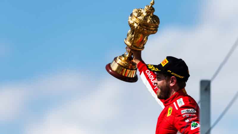 Sebastian Vettel holds the British Grand Prix trophy after winning the f1 race in 2018