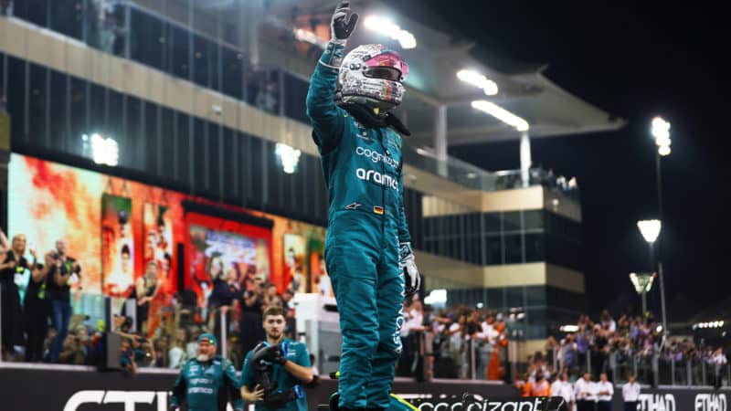 Sebastian Vettel stands on his Aston Martin and wvaes to the crowd after his final F1 race at the 2022 Abu Dhabi Grand Prix
