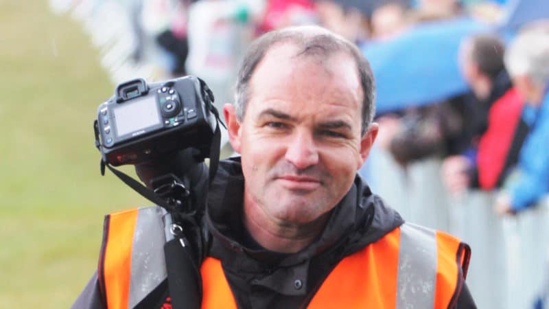 Simon Arron with camera and hi vis jacket