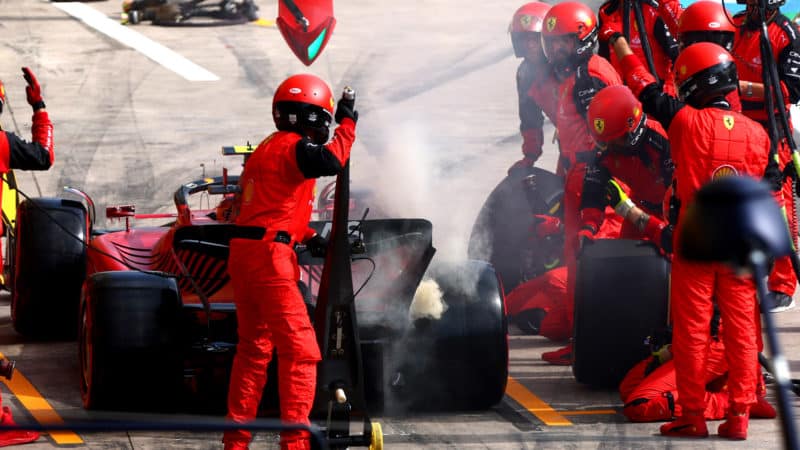 Smoke from the rear brake of Carlos Sainz Ferrari in the pits at the 2022 Brazilian Grand Prix