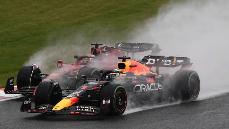 Charles Leclerc runs side by side with Max verstappen in the wet Japanese Grand Prix