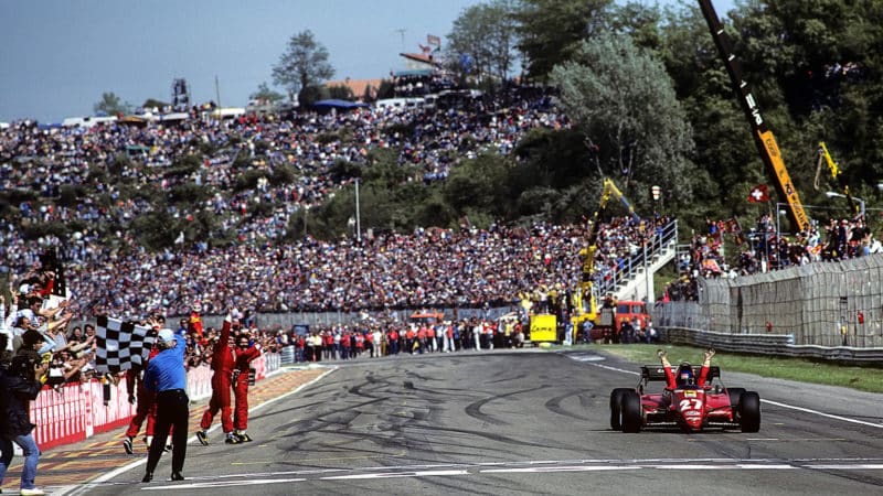 Patrick Tambay raises his arms in Ferrari as he wins 1983 San Marino GP