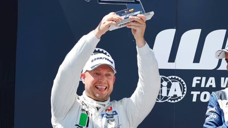 Rob Huff pokes his tongue out as he celebrates on WTCR podium