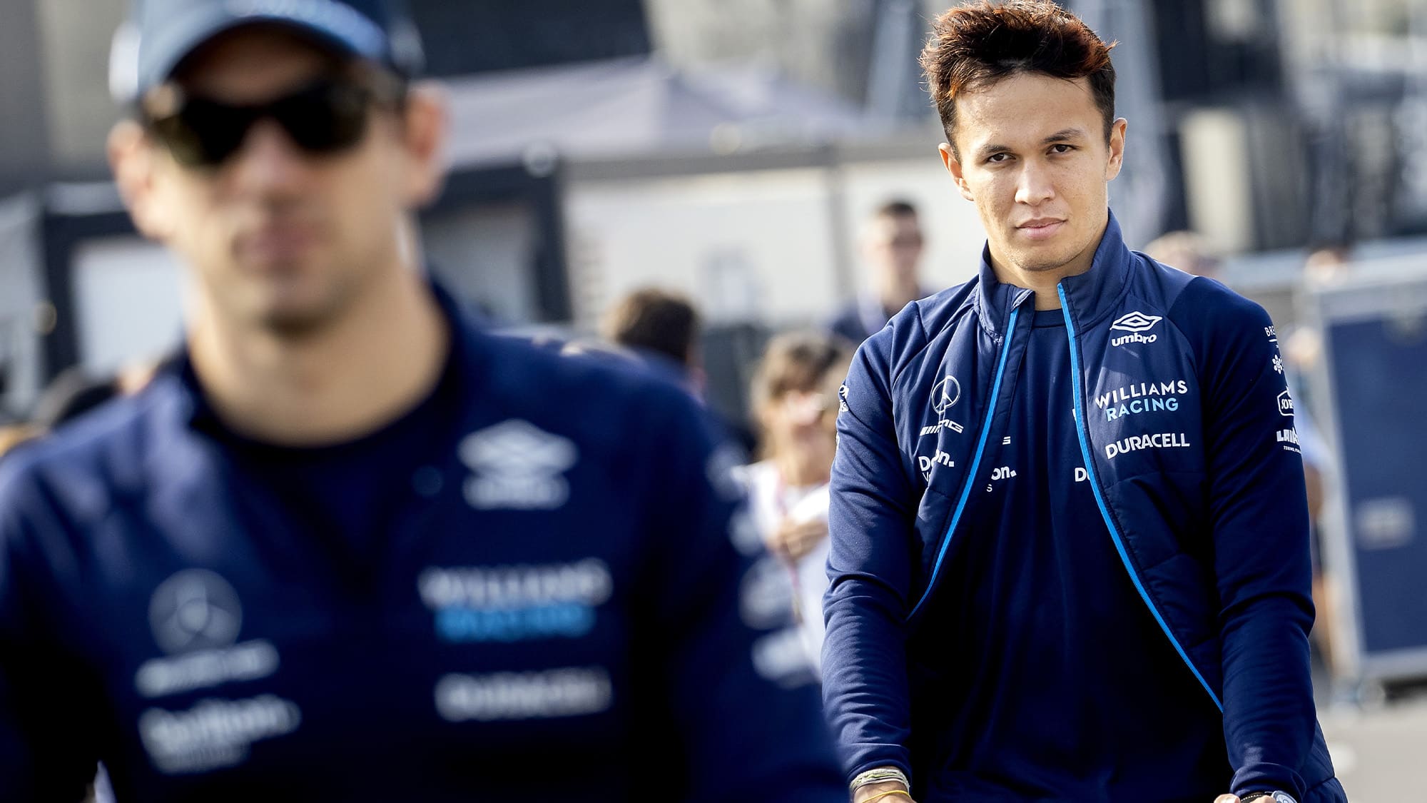 Alex Albon in focus behind blurred Nicholas Latifi