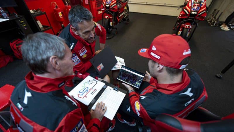 Cristhian Pupulin and Jack Miller debrief with telemetry in Ducati MotoGP garage