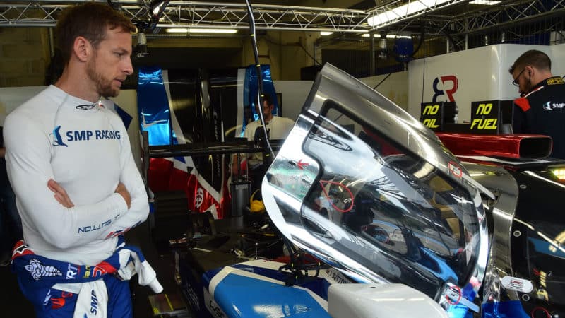Jenson Button looks at SMP Racing LMP1 car at Le Mans in 2018