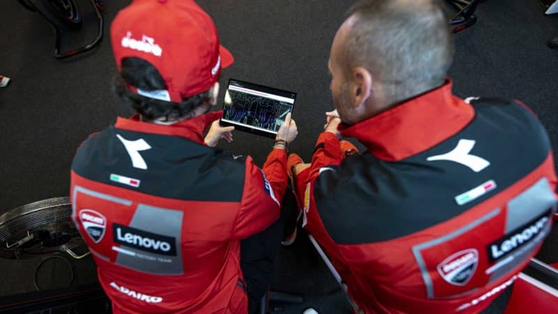 Pecco Bagnaia and Bagnaia and Cristian Gabarrini examine MotoGP telemetry