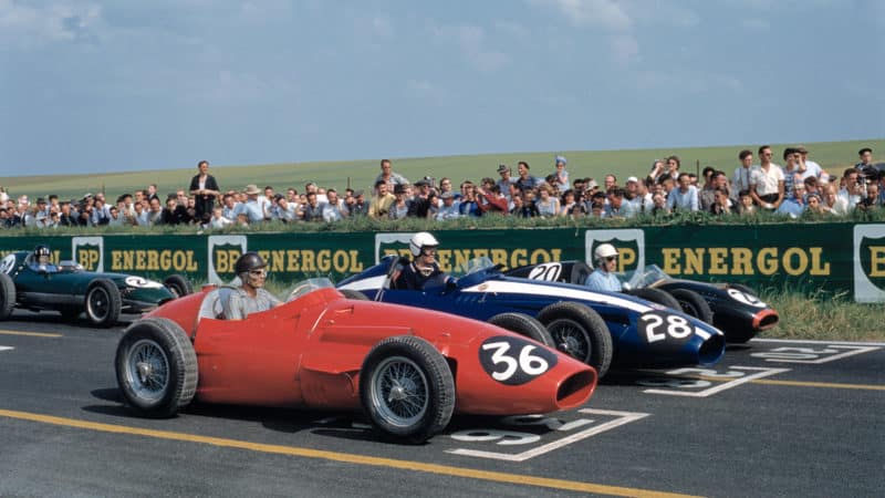Phil Hill with Carroll Shelby and Roy Salvadori on the grid at Reims for the 1958 French Grand Prix