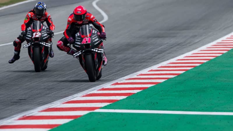 Pol Espargaro and Maverick Vinales approach a corner on Aprilia MotoGP bikes