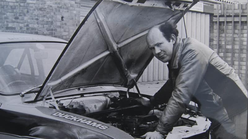 Tony Fowkes looks under the bonnet of Ford Escort outside his garage