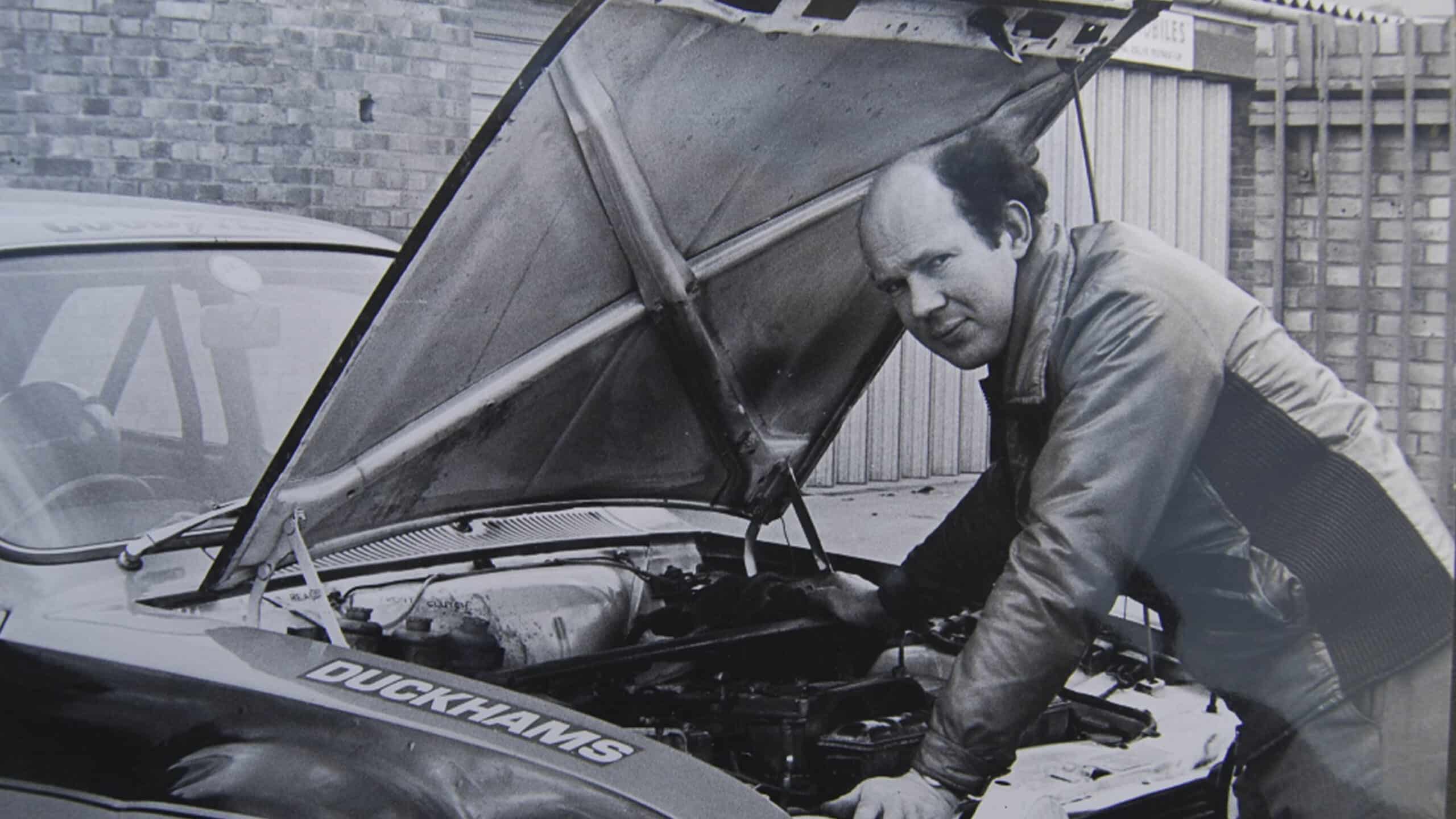 Tony Fowkes looks under the bonnet of Ford Escort outside his garage