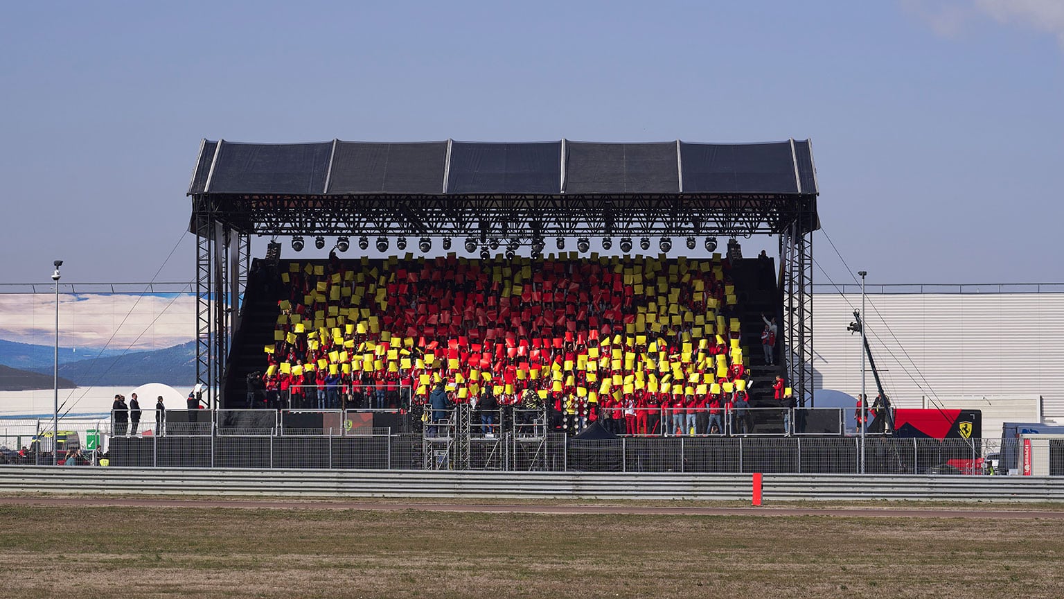 The new Ferrari drives past a packed grandstand on its launch day